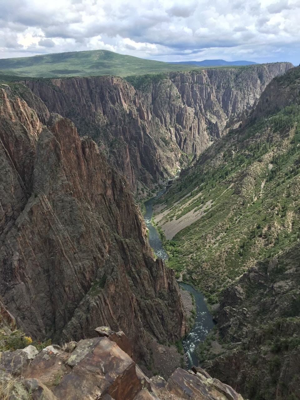 Color photo looking down into Black Canyon of the Gunnision from the edge.