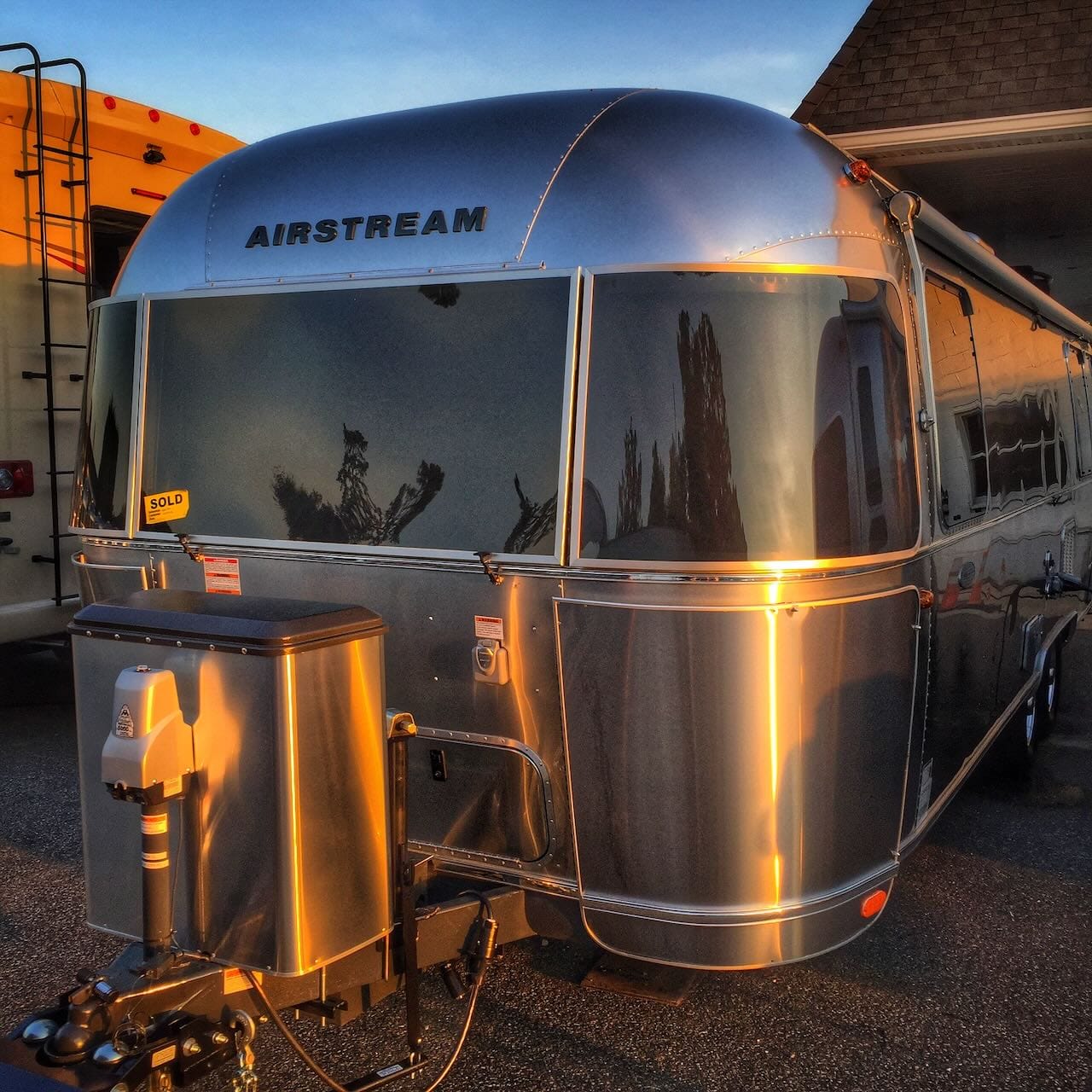 Color photo of our brand new Airstream travel trailer on the dealer lot.