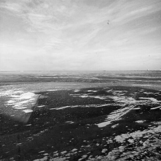 B&W photo of steam rising of Lake Hefner