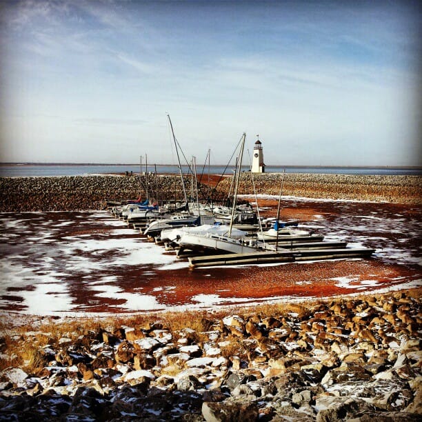 Color photo of sail boats resting on the lake bed of Lake Hefner.